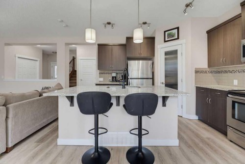 145 Sunset Manor, Cochrane, AB - Indoor Photo Showing Kitchen With Stainless Steel Kitchen With Upgraded Kitchen