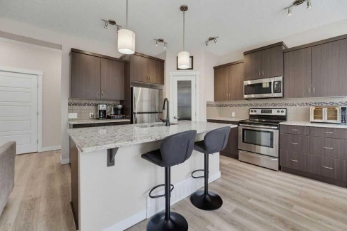 145 Sunset Manor, Cochrane, AB - Indoor Photo Showing Kitchen With Stainless Steel Kitchen With Upgraded Kitchen