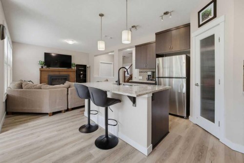 145 Sunset Manor, Cochrane, AB - Indoor Photo Showing Kitchen With Stainless Steel Kitchen With Upgraded Kitchen