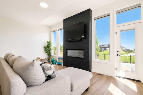 267 Belmont Heath Sw, Calgary, AB - Indoor Photo Showing Bedroom With Fireplace