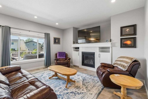 7 Bishop Circle, Carstairs, AB - Indoor Photo Showing Living Room With Fireplace