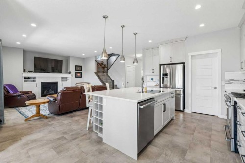 7 Bishop Circle, Carstairs, AB - Indoor Photo Showing Kitchen With Fireplace With Stainless Steel Kitchen With Upgraded Kitchen