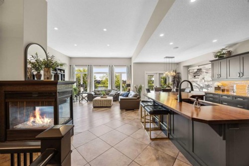 469 Rainbow Falls Way, Chestermere, AB - Indoor Photo Showing Kitchen With Fireplace With Double Sink With Upgraded Kitchen