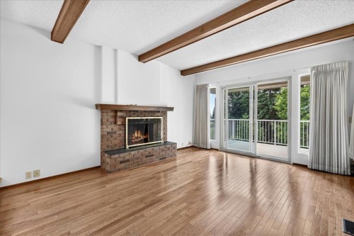 212 Stravanan Bay Sw, Calgary, AB - Indoor Photo Showing Living Room With Fireplace