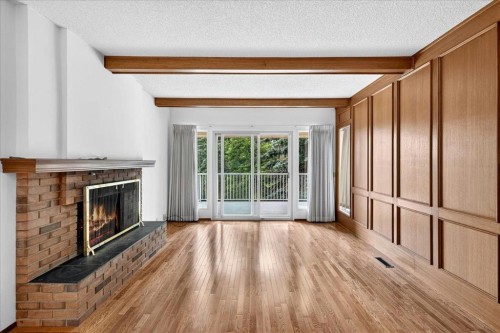 212 Stravanan Bay Sw, Calgary, AB - Indoor Photo Showing Living Room With Fireplace