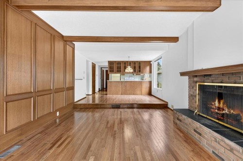 212 Stravanan Bay Sw, Calgary, AB - Indoor Photo Showing Other Room With Fireplace