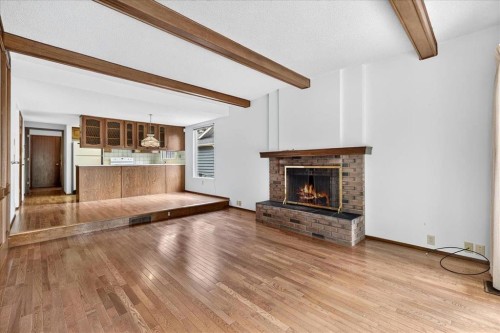212 Stravanan Bay Sw, Calgary, AB - Indoor Photo Showing Living Room With Fireplace