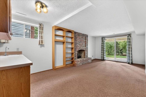 212 Stravanan Bay Sw, Calgary, AB - Indoor With Fireplace
