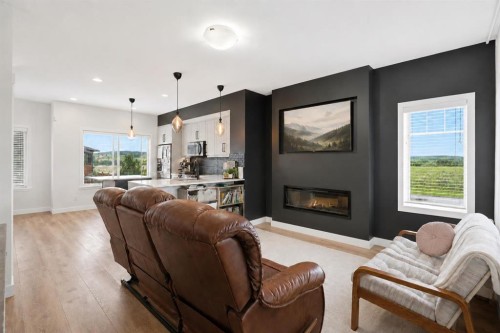 1801-32 Horseshoe Crescent, Cochrane, AB - Indoor Photo Showing Living Room With Fireplace
