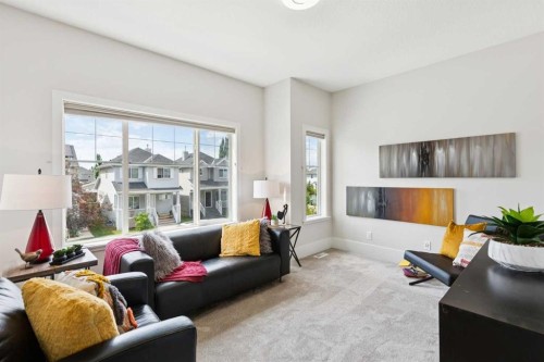 257 Cougartown Circle Sw, Calgary, AB - Indoor Photo Showing Living Room With Fireplace