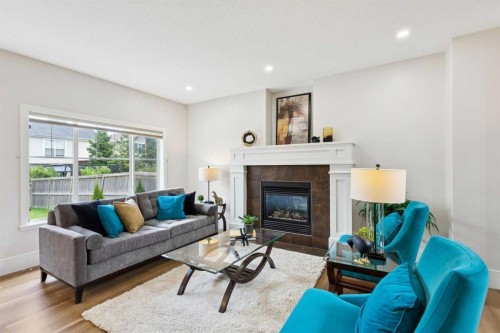 257 Cougartown Circle Sw, Calgary, AB - Indoor Photo Showing Living Room With Fireplace
