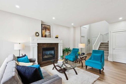 257 Cougartown Circle Sw, Calgary, AB - Indoor Photo Showing Living Room With Fireplace