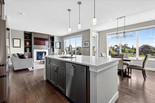 69 Cimarron Springs Circle, Okotoks, AB - Indoor Photo Showing Kitchen With Fireplace With Double Sink With Upgraded Kitchen