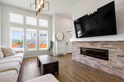 31 Magnolia Grove Se, Calgary, AB - Indoor Photo Showing Living Room With Fireplace