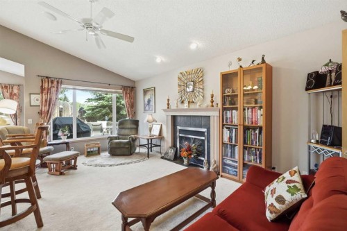 164 Sunterra Heights, Cochrane, AB - Indoor Photo Showing Living Room With Fireplace