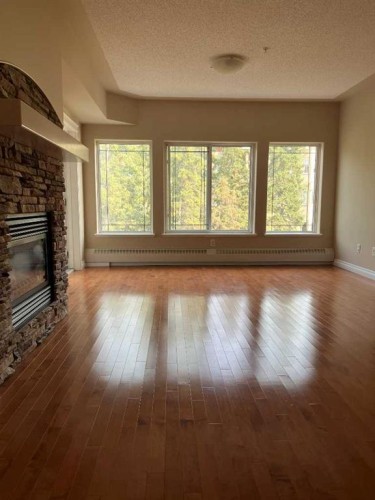 305-30 Discovery Ridge Close Sw, Calgary, AB - Indoor Photo Showing Living Room With Fireplace