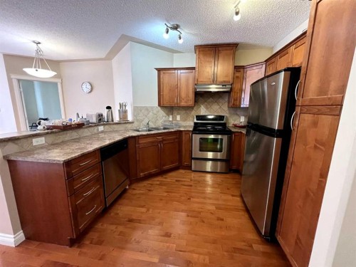 305-30 Discovery Ridge Close Sw, Calgary, AB - Indoor Photo Showing Kitchen With Double Sink