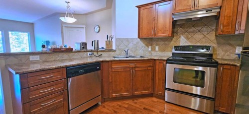 305-30 Discovery Ridge Close Sw, Calgary, AB - Indoor Photo Showing Kitchen With Double Sink