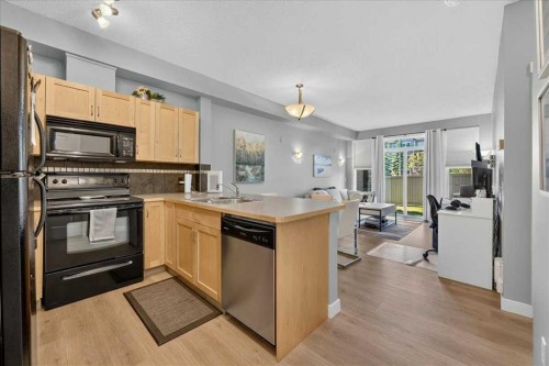 2103-211 Aspen Stone Boulevard Sw, Calgary, AB - Indoor Photo Showing Kitchen With Double Sink