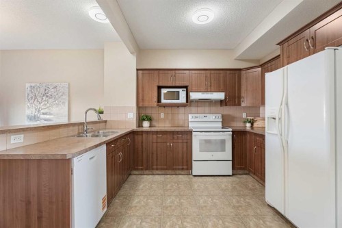 40 Cimarron Grove Drive, Okotoks, AB - Indoor Photo Showing Kitchen With Double Sink