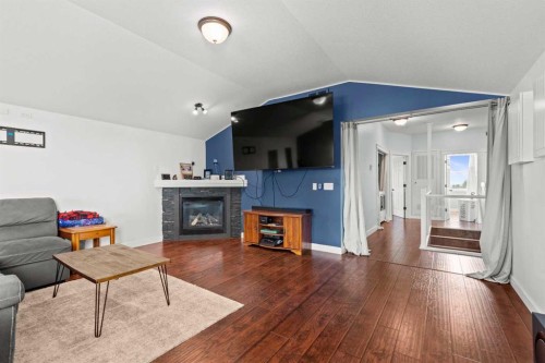 13 Cherry Lane Se, Three Hills, AB - Indoor Photo Showing Living Room With Fireplace
