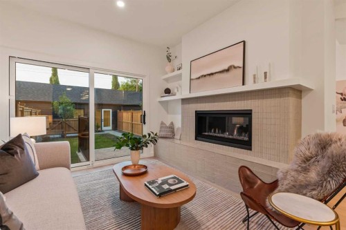 2-8916 33 Avenue Nw, Calgary, AB - Indoor Photo Showing Living Room With Fireplace