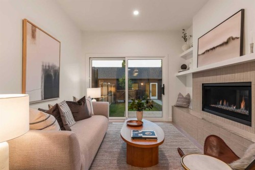 2-8916 33 Avenue Nw, Calgary, AB - Indoor Photo Showing Living Room With Fireplace