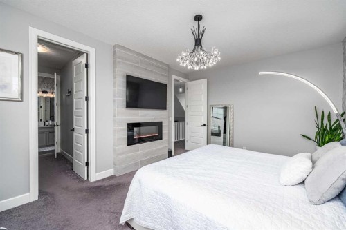 46 Yorkstone Way Sw, Calgary, AB - Indoor Photo Showing Bedroom With Fireplace