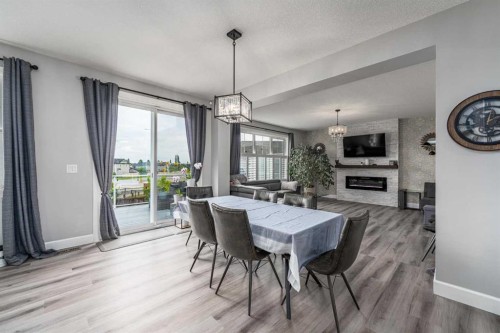 46 Yorkstone Way Sw, Calgary, AB - Indoor Photo Showing Dining Room With Fireplace