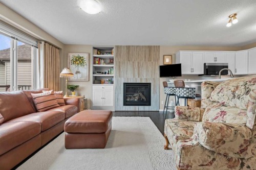 241 Sunset Heights, Cochrane, AB - Indoor Photo Showing Living Room With Fireplace