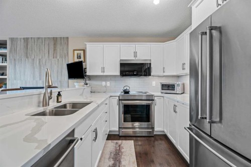 241 Sunset Heights, Cochrane, AB - Indoor Photo Showing Kitchen With Double Sink