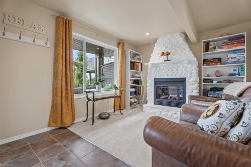 241 Sunset Heights, Cochrane, AB - Indoor Photo Showing Other Room With Fireplace