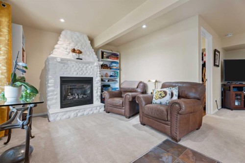 241 Sunset Heights, Cochrane, AB - Indoor Photo Showing Living Room With Fireplace