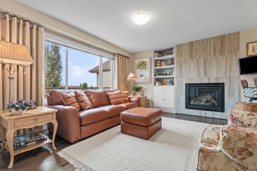 241 Sunset Heights, Cochrane, AB - Indoor Photo Showing Living Room With Fireplace