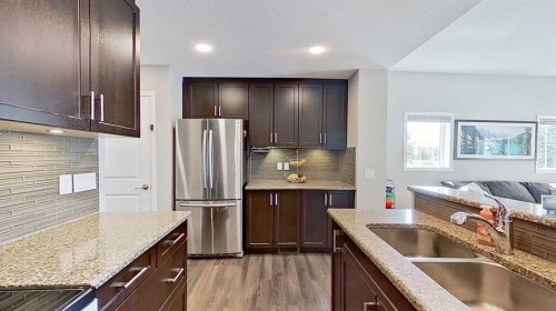 39 Sunrise View, Cochrane, AB - Indoor Photo Showing Kitchen With Double Sink With Upgraded Kitchen