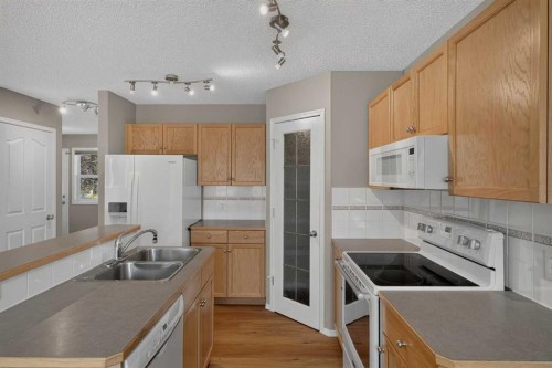 59 Silver Springs Way Nw, Airdrie, AB - Indoor Photo Showing Kitchen With Double Sink