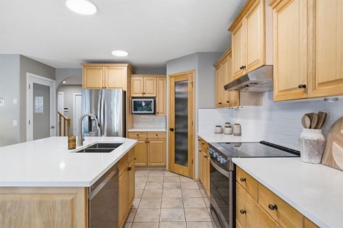 132 Coopers Heights Sw, Airdrie, AB - Indoor Photo Showing Kitchen With Stainless Steel Kitchen With Double Sink With Upgraded Kitchen