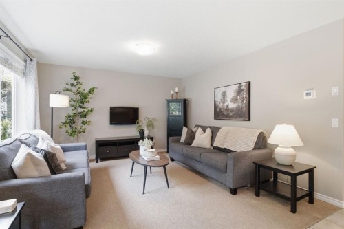 132 Coopers Heights Sw, Airdrie, AB - Indoor Photo Showing Living Room