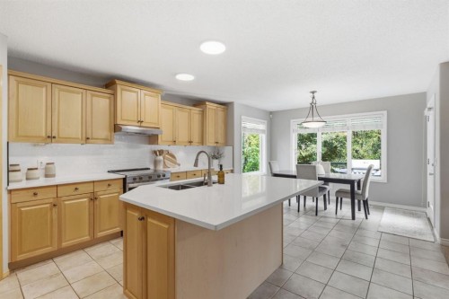 132 Coopers Heights Sw, Airdrie, AB - Indoor Photo Showing Kitchen With Double Sink