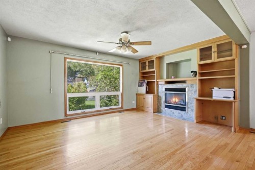 806 Radford Road Ne, Calgary, AB - Indoor Photo Showing Living Room With Fireplace