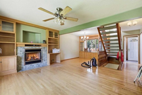806 Radford Road Ne, Calgary, AB - Indoor Photo Showing Living Room With Fireplace