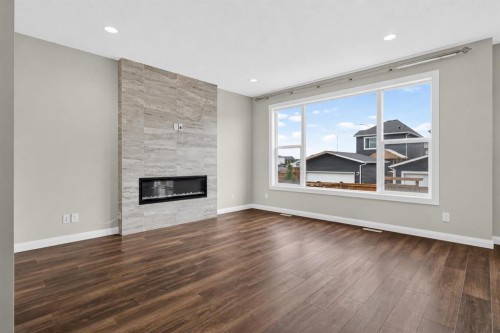 62 Evansfield Green Nw, Calgary, AB - Indoor Photo Showing Living Room With Fireplace
