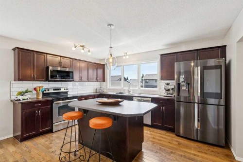 147 Sunset Cove, Cochrane, AB - Indoor Photo Showing Kitchen With Stainless Steel Kitchen With Double Sink With Upgraded Kitchen