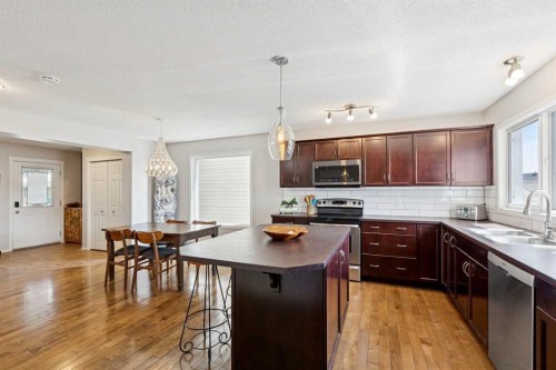147 Sunset Cove, Cochrane, AB - Indoor Photo Showing Kitchen With Stainless Steel Kitchen With Upgraded Kitchen