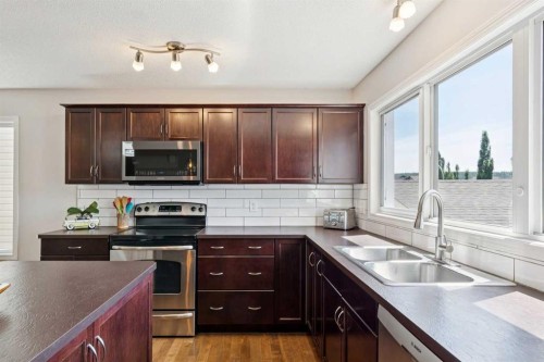147 Sunset Cove, Cochrane, AB - Indoor Photo Showing Kitchen With Stainless Steel Kitchen With Double Sink