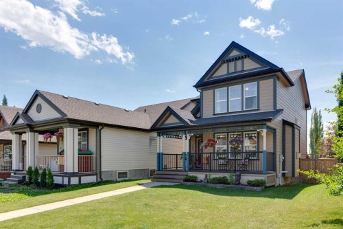 147 Sunset Cove, Cochrane, AB - Outdoor With Deck Patio Veranda With Facade