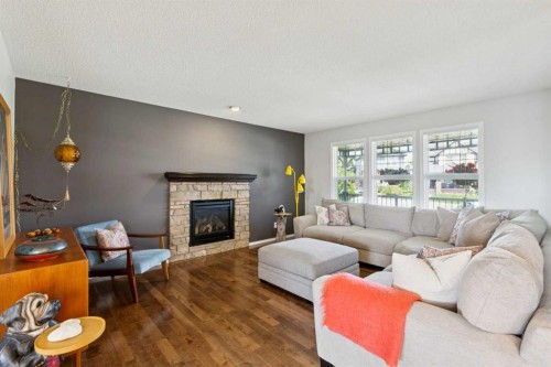 147 Sunset Cove, Cochrane, AB - Indoor Photo Showing Living Room With Fireplace