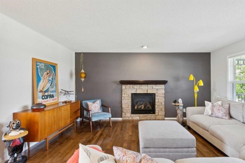 147 Sunset Cove, Cochrane, AB - Indoor Photo Showing Living Room With Fireplace