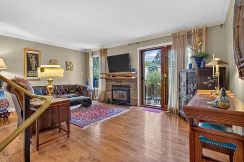 12-140 Point Drive Nw, Calgary, AB - Indoor Photo Showing Living Room With Fireplace