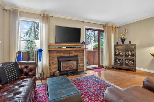 12-140 Point Drive Nw, Calgary, AB - Indoor Photo Showing Living Room With Fireplace
